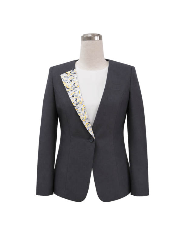 Women's single-button corporate suit blazer in dark charcoal grey featuring a yellow and grey abstract leaf printed lapel facing and structured waist contouring, designed for bank tellers and financial consultants by Modoleen Singapore.