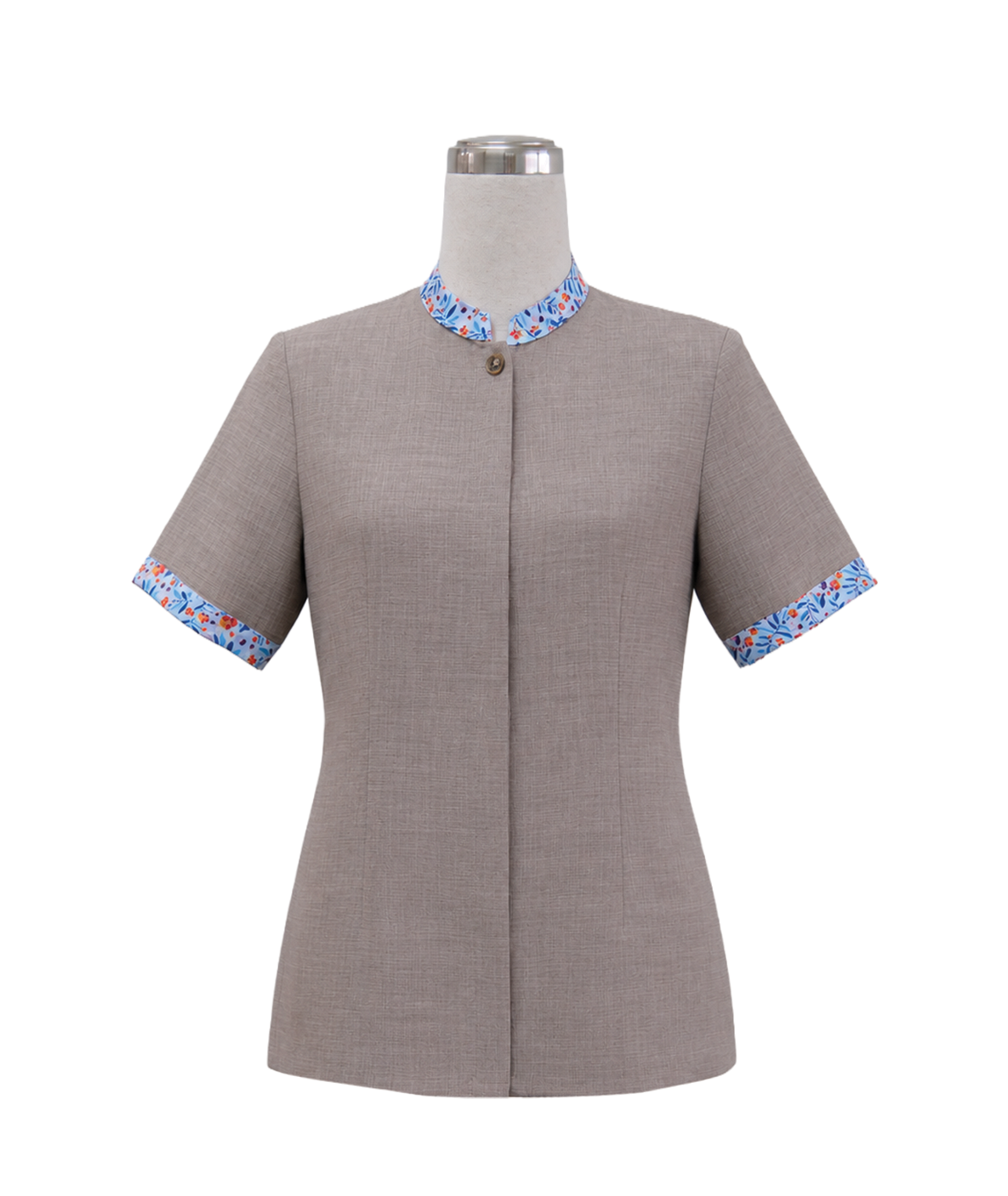modoleen-beige-stand-collar-corporate-shirt-floral-trim.jpg Women's short-sleeve corporate tunic top in taupe grey featuring a standing collar, single accent button, covered placket, and vibrant blue and orange floral trim along the collar and sleeve cuffs, designed by Modoleen Singapore for clinic, spa, and receptionist uniform programs.