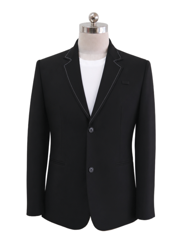 Men's classic two-button corporate suit blazer in solid black featuring tailored notch lapels with distinctive white contrast stitching and side flap pockets, styled over a white shirt, designed by Modoleen Singapore for corporate leadership and hospitality uniform programs.