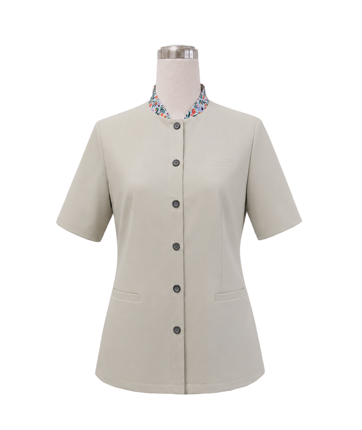 modoleen-green-stand-collar-corporate-shirt-floral-trim.jpg Women's short-sleeve corporate uniform tunic in light cream beige featuring a standing collar with colorful floral inner lining, front button closure, and hip welt pockets, designed by Modoleen Singapore for clinic, spa, and receptionist uniform programs.
