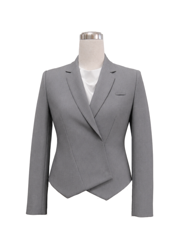 Women's light grey executive blazer featuring an asymmetric overlapping front crossover fold, tailored notch lapels, and fitted waist contouring, designed by Modoleen Singapore with customizable color and trim options for corporate uniform programs.