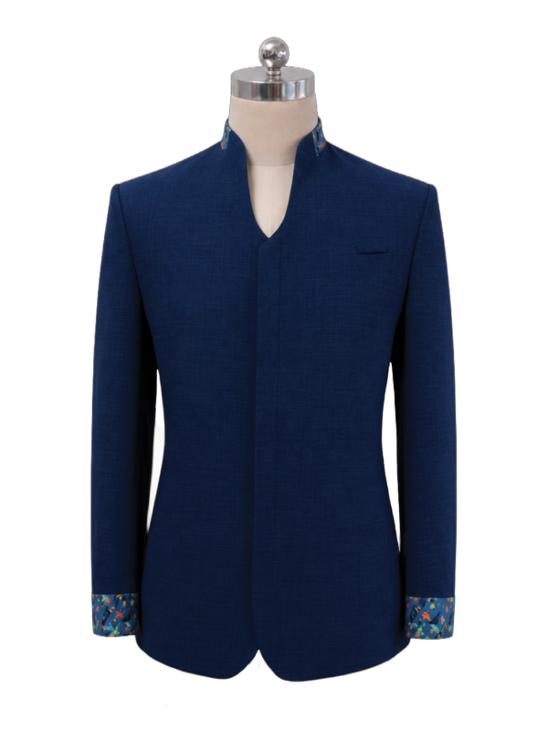 Men's corporate standing collar jacket in dark navy blue featuring a clean V-cut neckline, concealed front placket, and vibrant tropical batik pattern accents along the inner collar and turned-up cuffs, designed by Modoleen Singapore for corporate leadership and hospitality uniform programs.