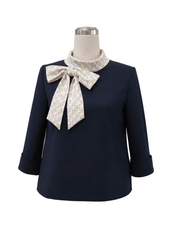 Women's navy blue 3/4 sleeve corporate top featuring a high neck collar with an integrated white and gold chain-link patterned bow tie, designed by Modoleen Singapore for office wear and corporate uniform programs.