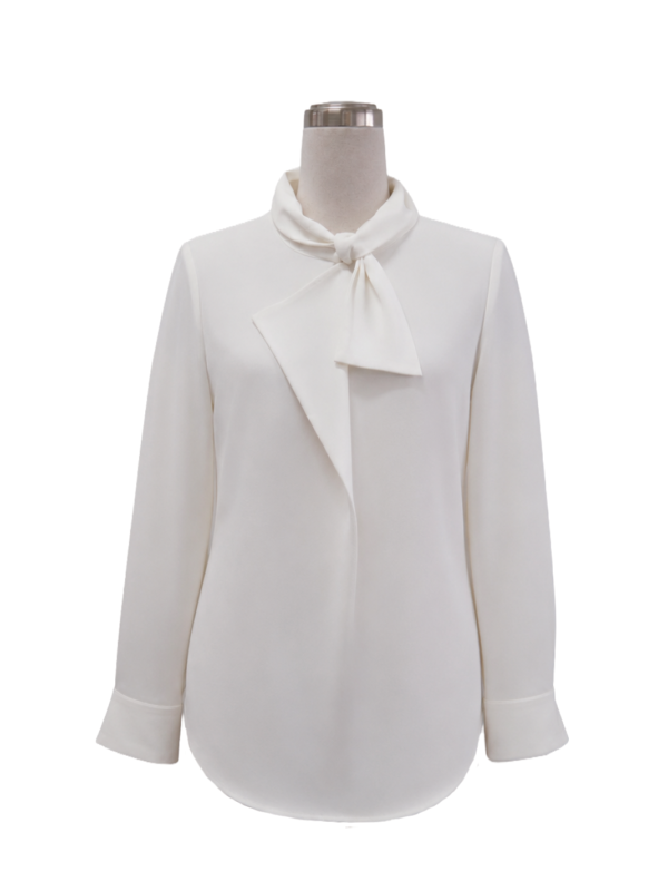 Women's long-sleeve white corporate blouse featuring a tied pussybow neck collar, curved hemline, and tailored cuffs, designed by Modoleen Singapore with custom color, print, and branding options for office and hospitality uniform programs.