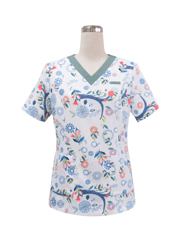 Women's short-sleeve medical scrub top featuring a teal-green V-neckline, custom printed floral pattern designed by Modoleen, and functional front pockets, tailored by Modoleen Singapore for healthcare, palliative care, and Assisi Hospice clinical staff uniform programs.