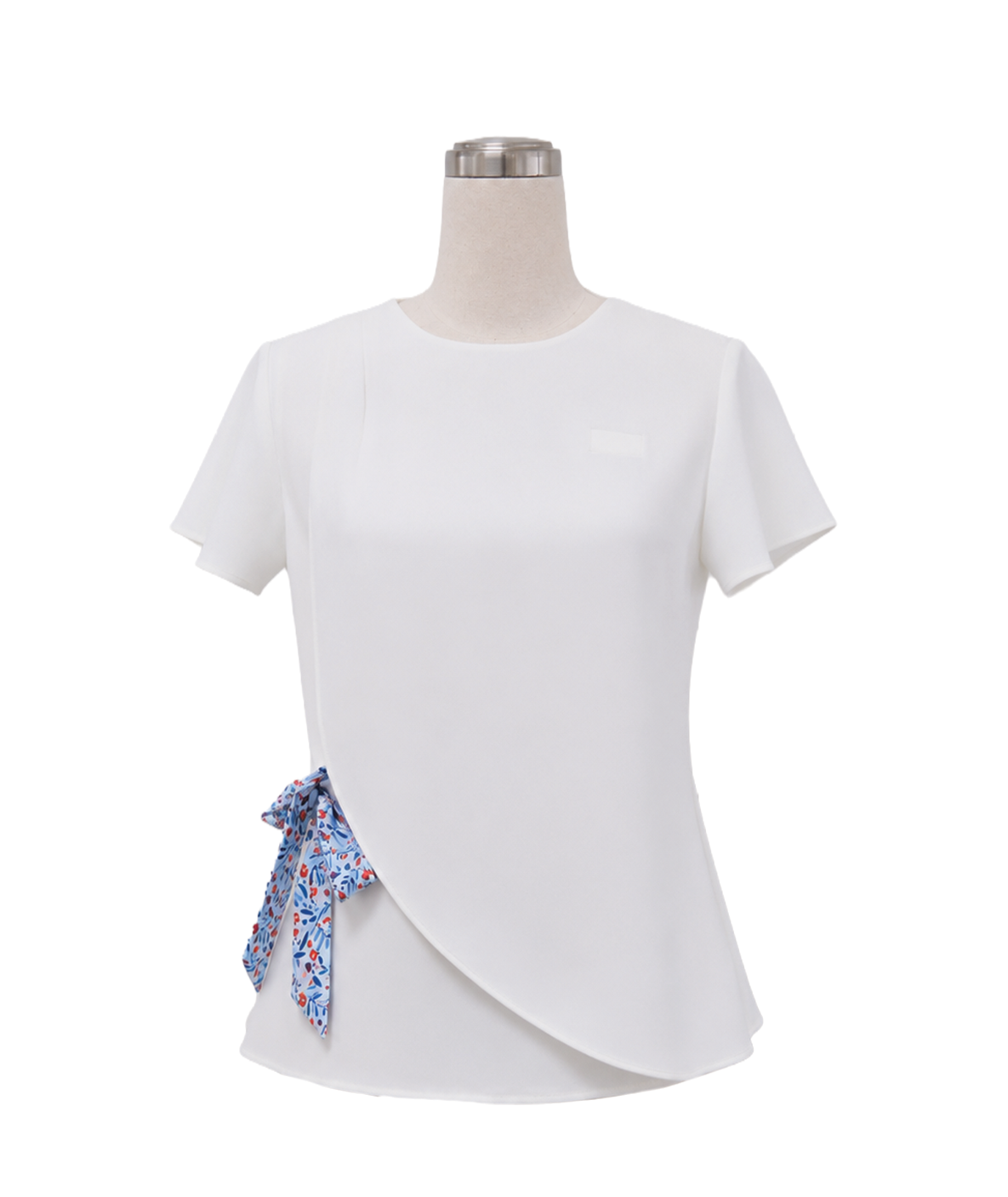 modoleen-white-short-sleeve-wrap-top-floral-bow-uniform.jpg Women's tailored short-sleeve corporate uniform top in solid white featuring an asymmetric curved wrap front hem and a blue and red floral patterned side-waist bow tie sash, designed by Modoleen Singapore for office wear and hospitality uniform programs.