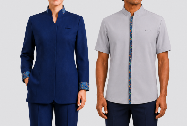 Corporate uniform set featuring a women's long-sleeve navy blue standing collar jacket with floral inner trim, alongside a men's short-sleeve light grey standing collar shirt with vertical floral placket trim, designed by Modoleen Singapore for receptionist and service staff.